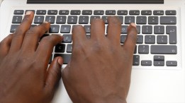 African-stock-video-of-black-man-hands-typing-on-a-laptop-computer